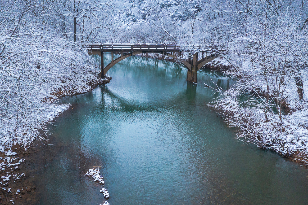 A historic bridge spans War Eagle Creek near Huntsville